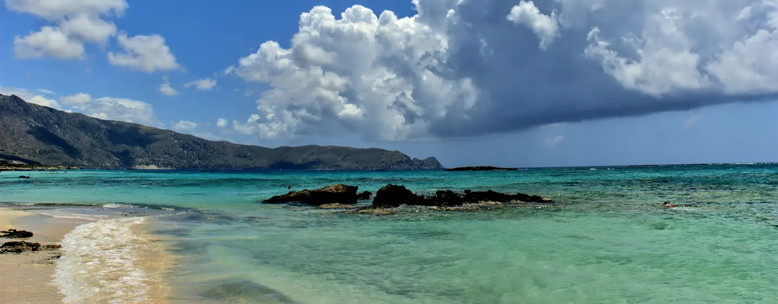 Rocky Crete coast beside clear blue water